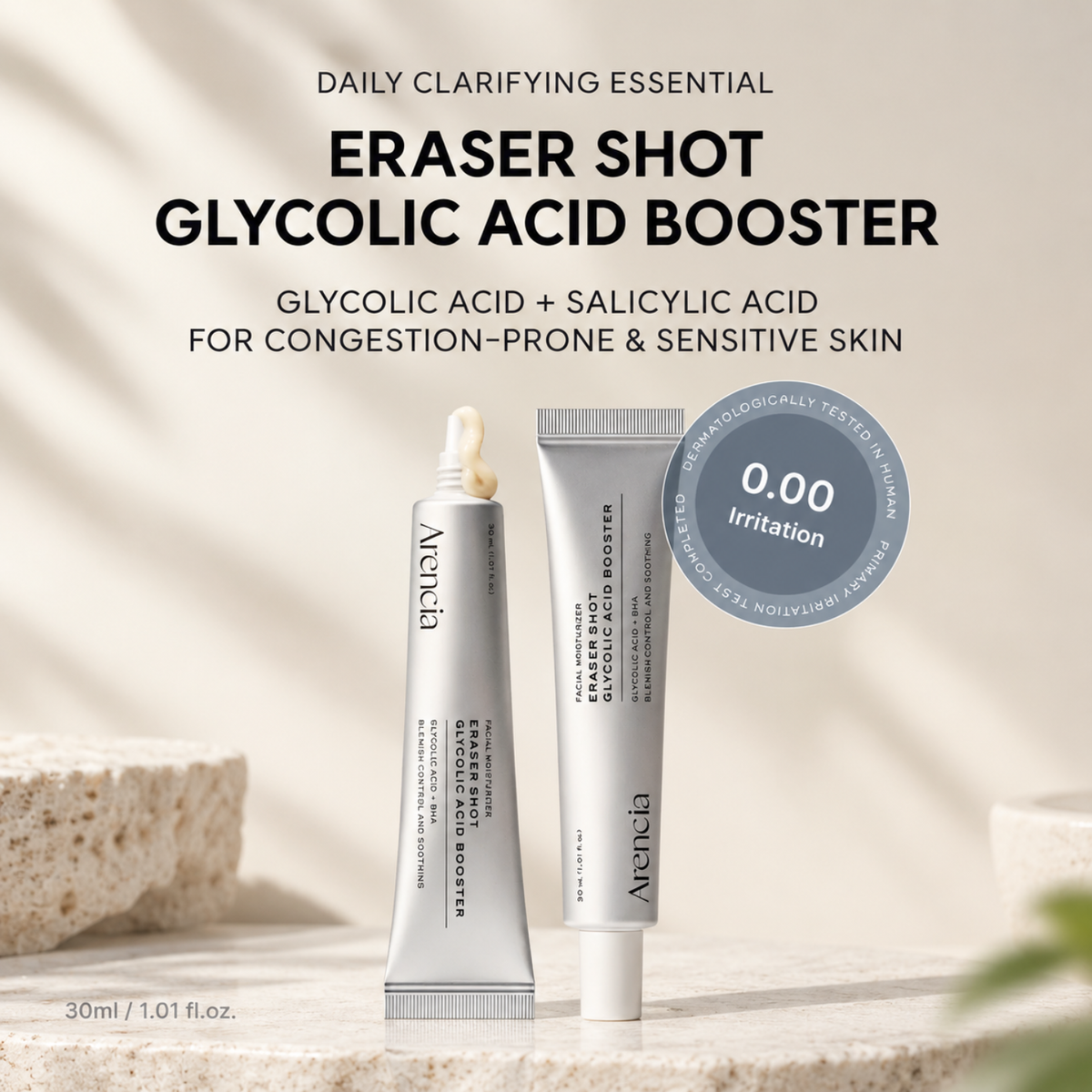 Two Areeba skincare tubes labeled 'Eraser Shot Glycolic Acid Booster' standing on a stone surface with a textured stone prop and soft shadow lighting. Large product text appears above, and a blue circular badge says '0.
