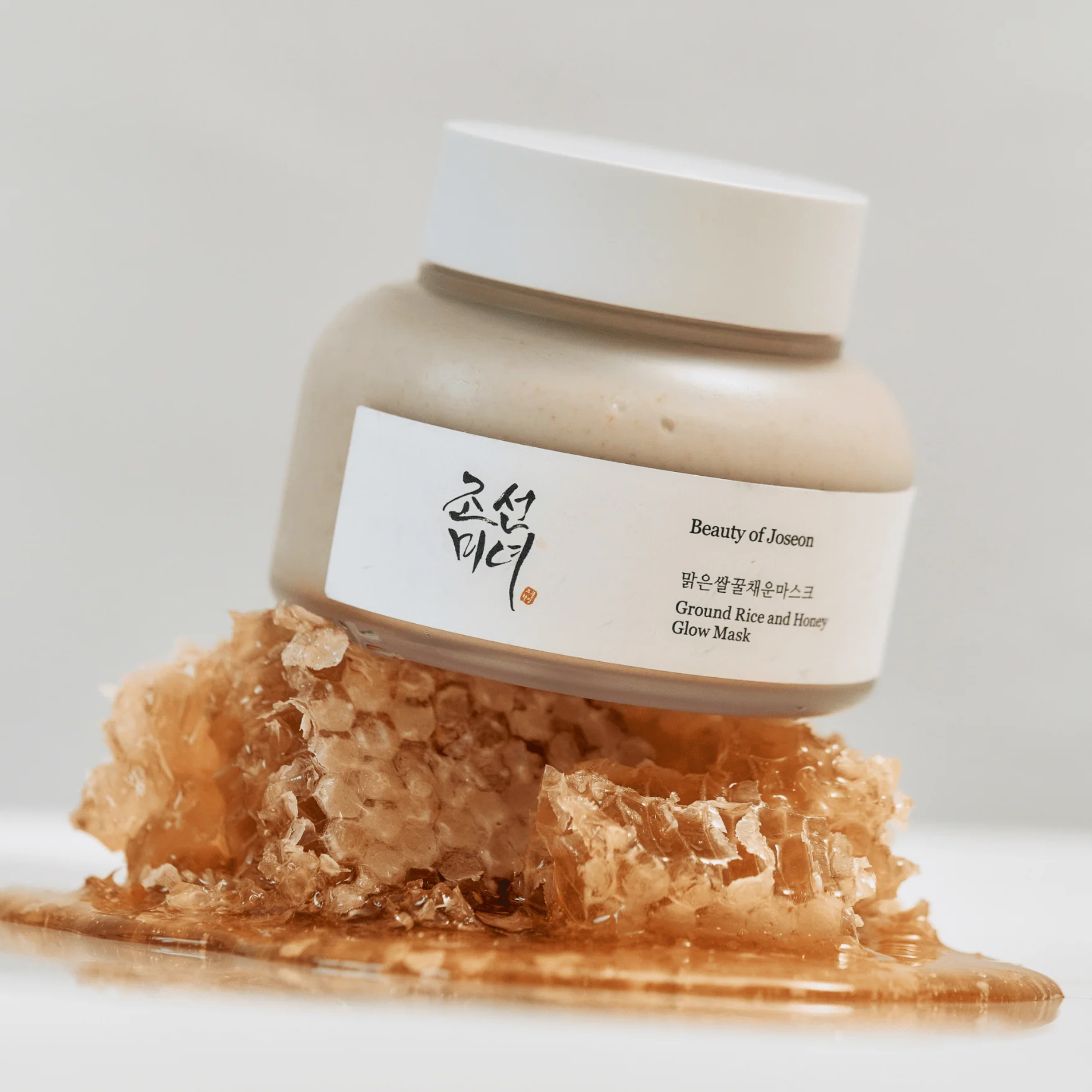 Jar of Beauty of Joseon Ground Rice and Honey Glow Mask with a crystal-like substance on a white background