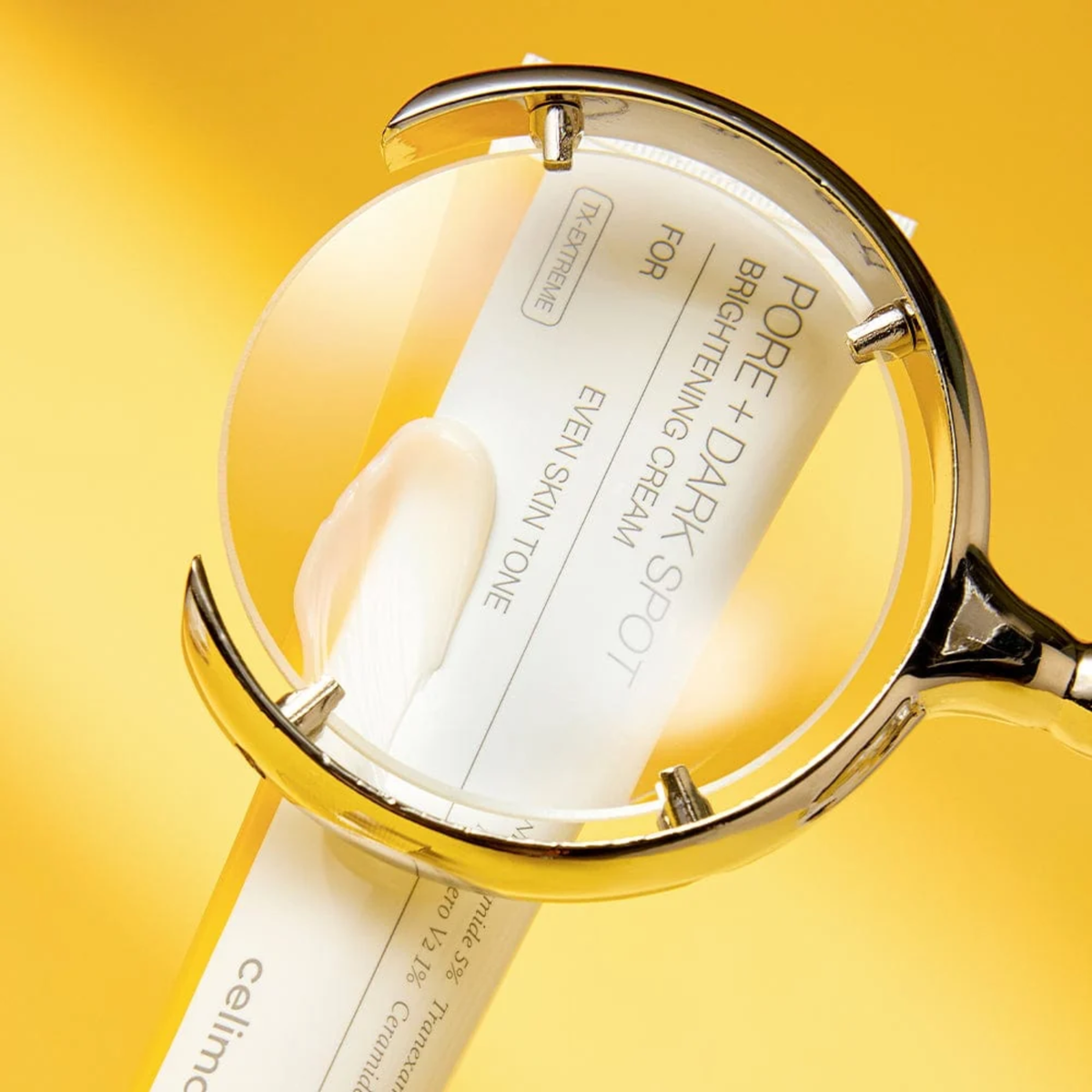 Cosmetic compact with a mirror on a yellow background