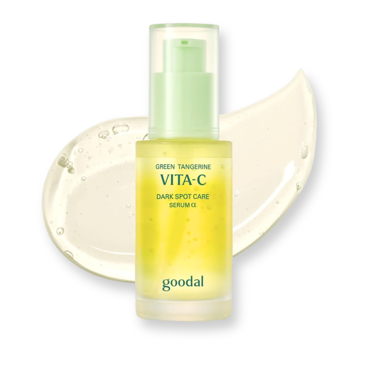 Goodal Vita-C Green Tangerine Dark Spot Care Serum in a clear bottle with a light green pump, shown in front of a translucent cream smear on a white background.