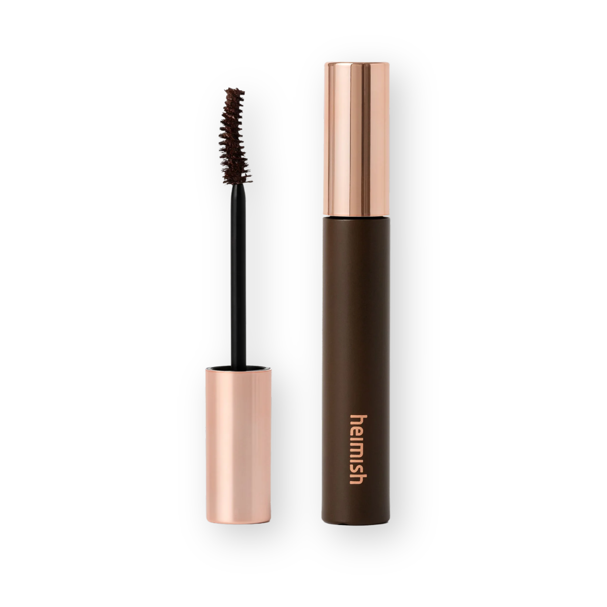 A tube of brow mascara with its wand removed, showing the spoolie brush. The tube is dark brown with a metallic rose gold cap and base, and the brand name 'harmish' is printed vertically in rose gold.