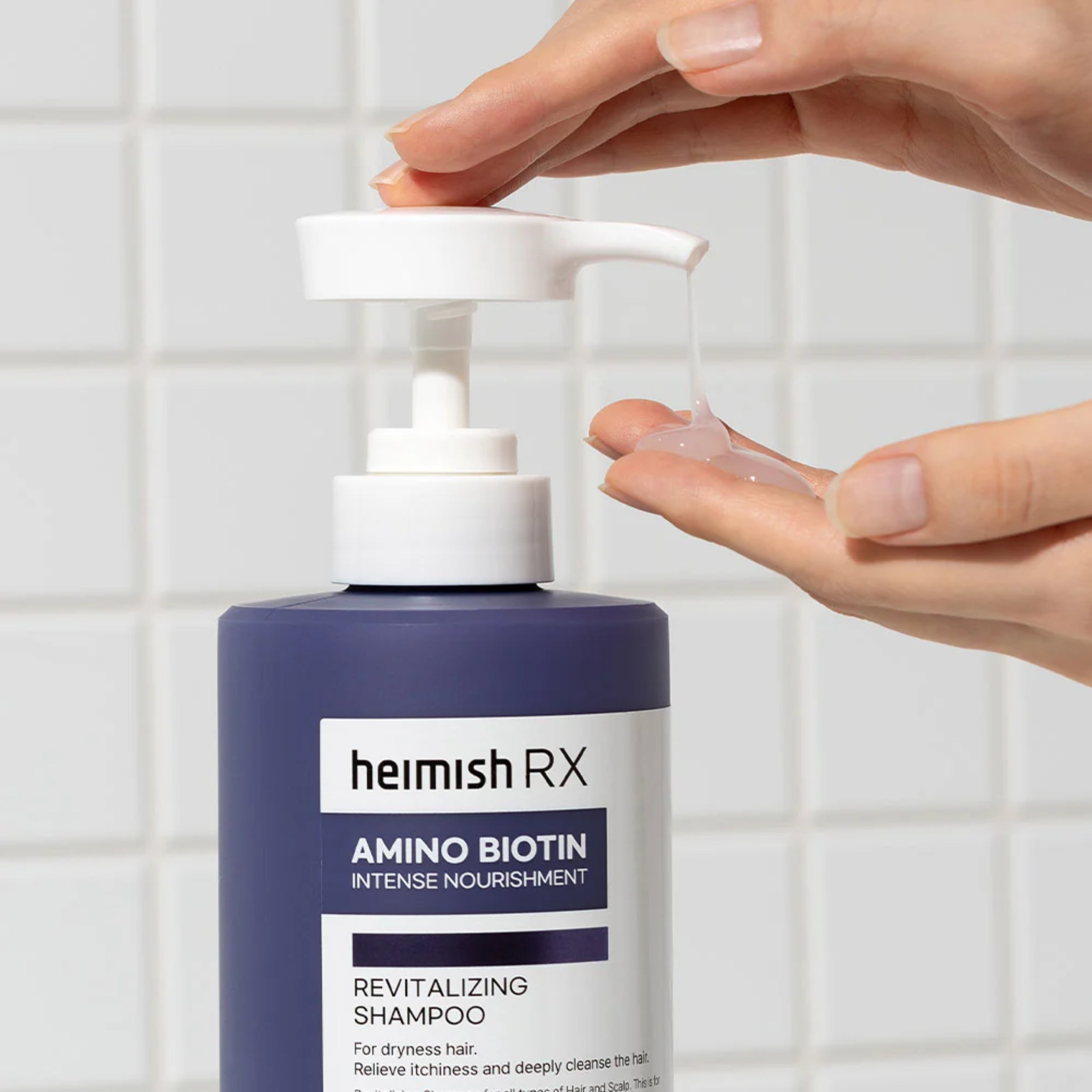 Heimish RX shampoo bottle with a hand holding the pump.