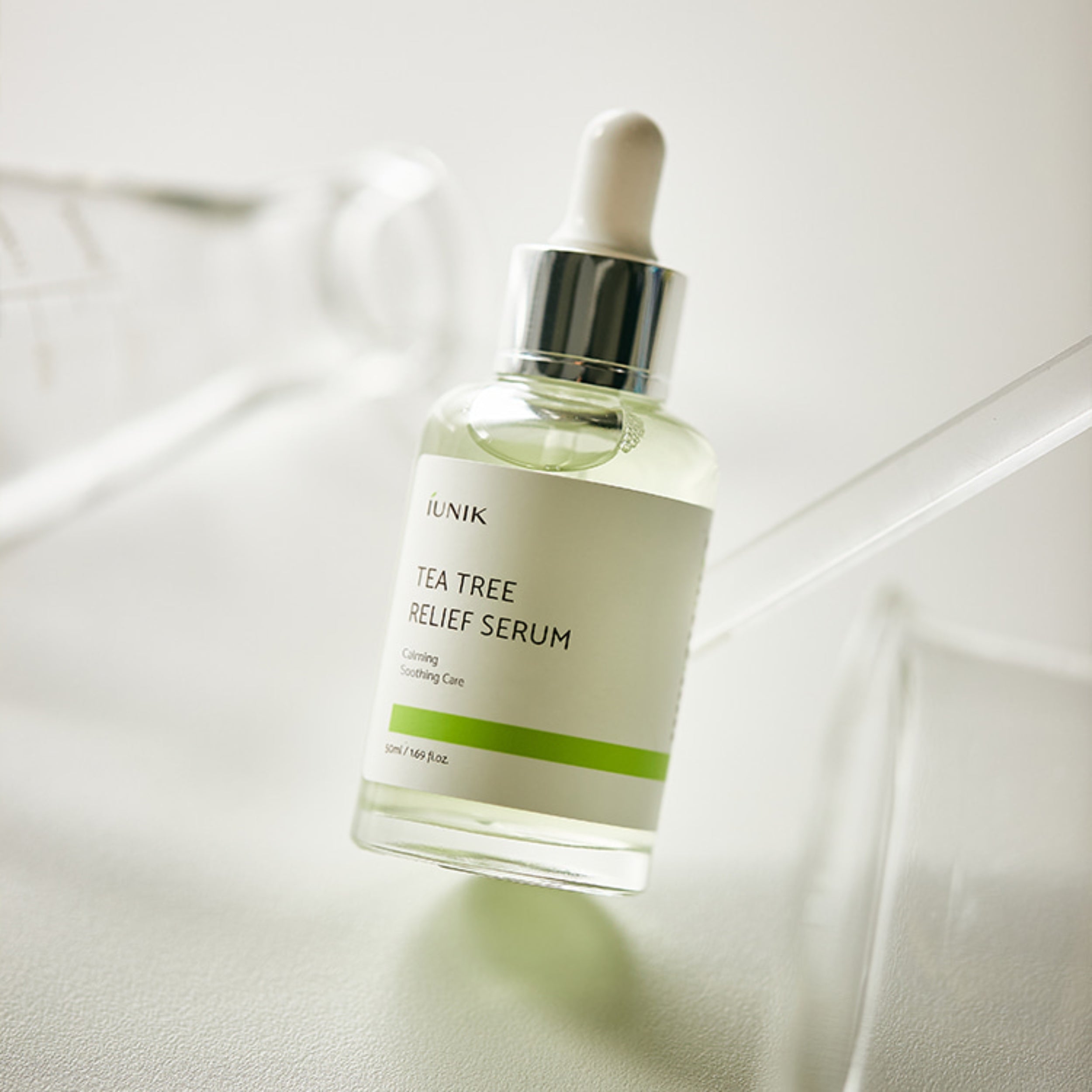Tea tree relief serum bottle on a light background