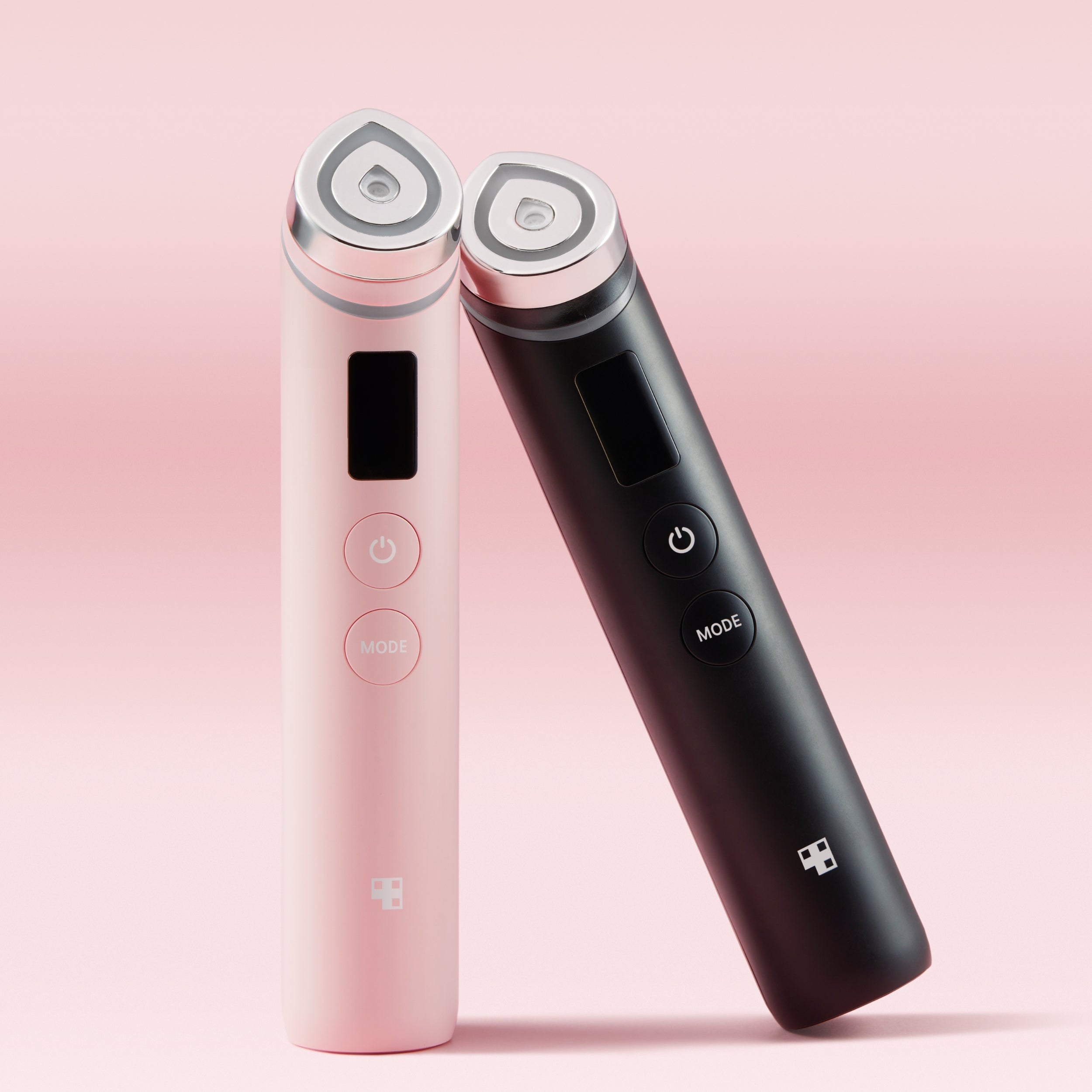 Pink and black handheld devices with digital displays on a pink background