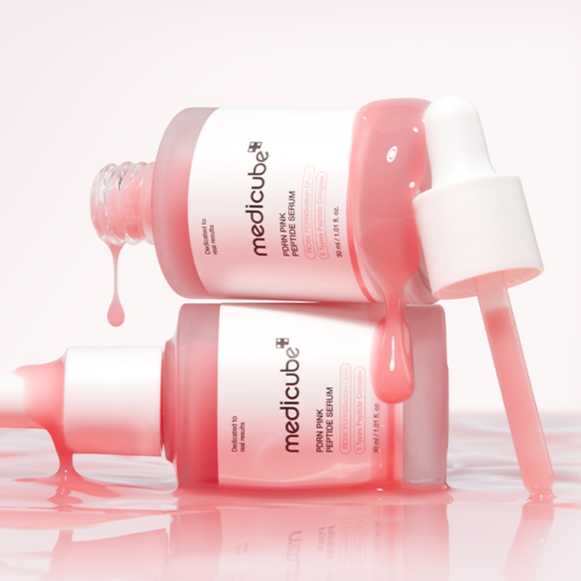 Medicube Pink Peptide Serum bottle with dropper on a white background