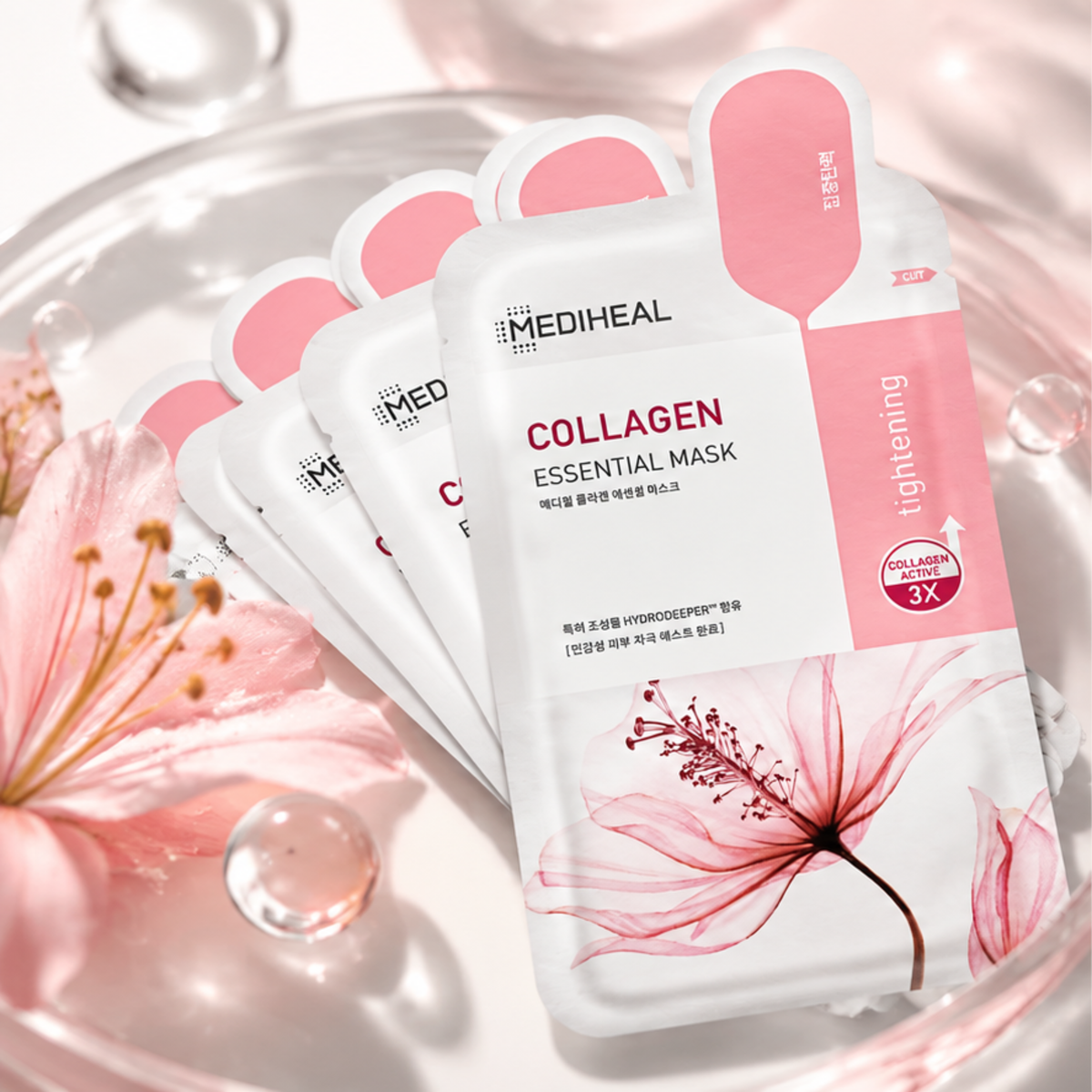 Four sheets of MEDIHEAL Collagen Essential Mask in a white and pink packaging, arranged on a glass dish with pink flowers and water droplets.