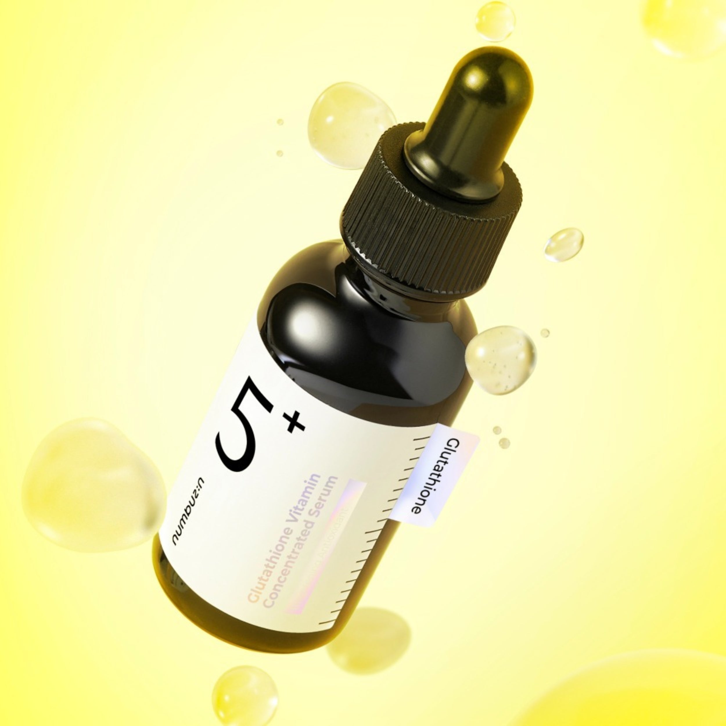 Black dropper bottle with a label on a yellow background