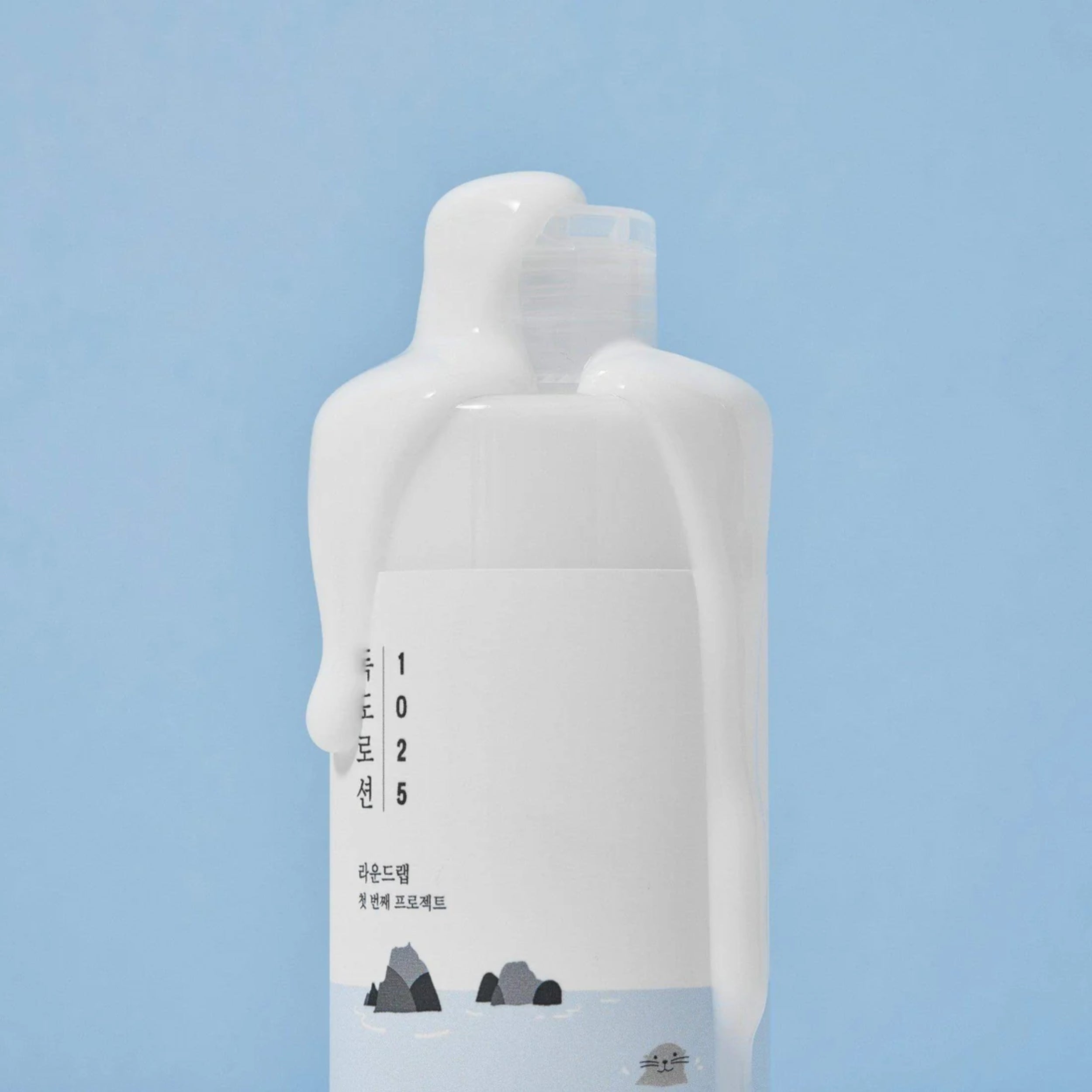 White bottle with a label on a light blue background