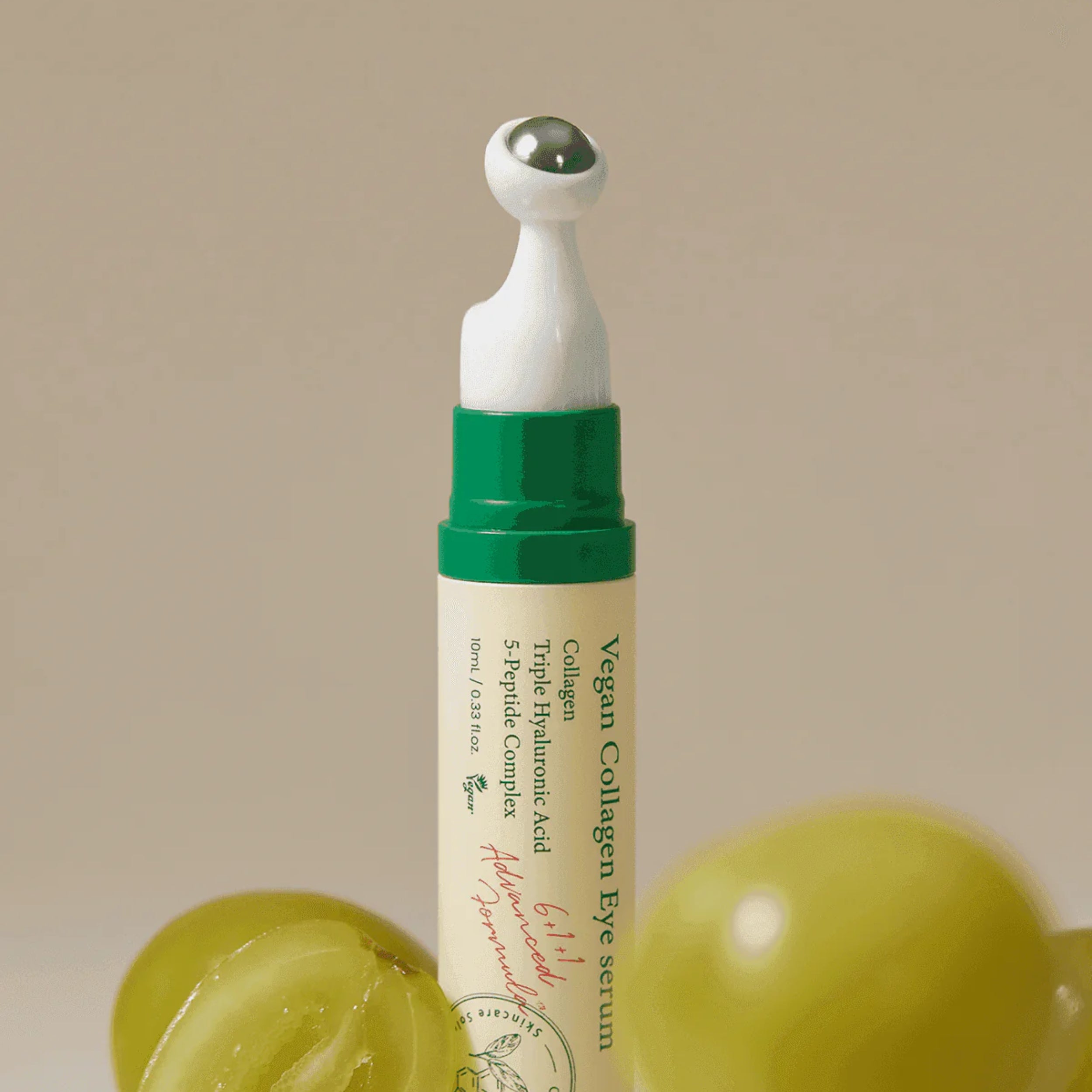 Vegan collagen eye serum with green and white packaging on a beige background