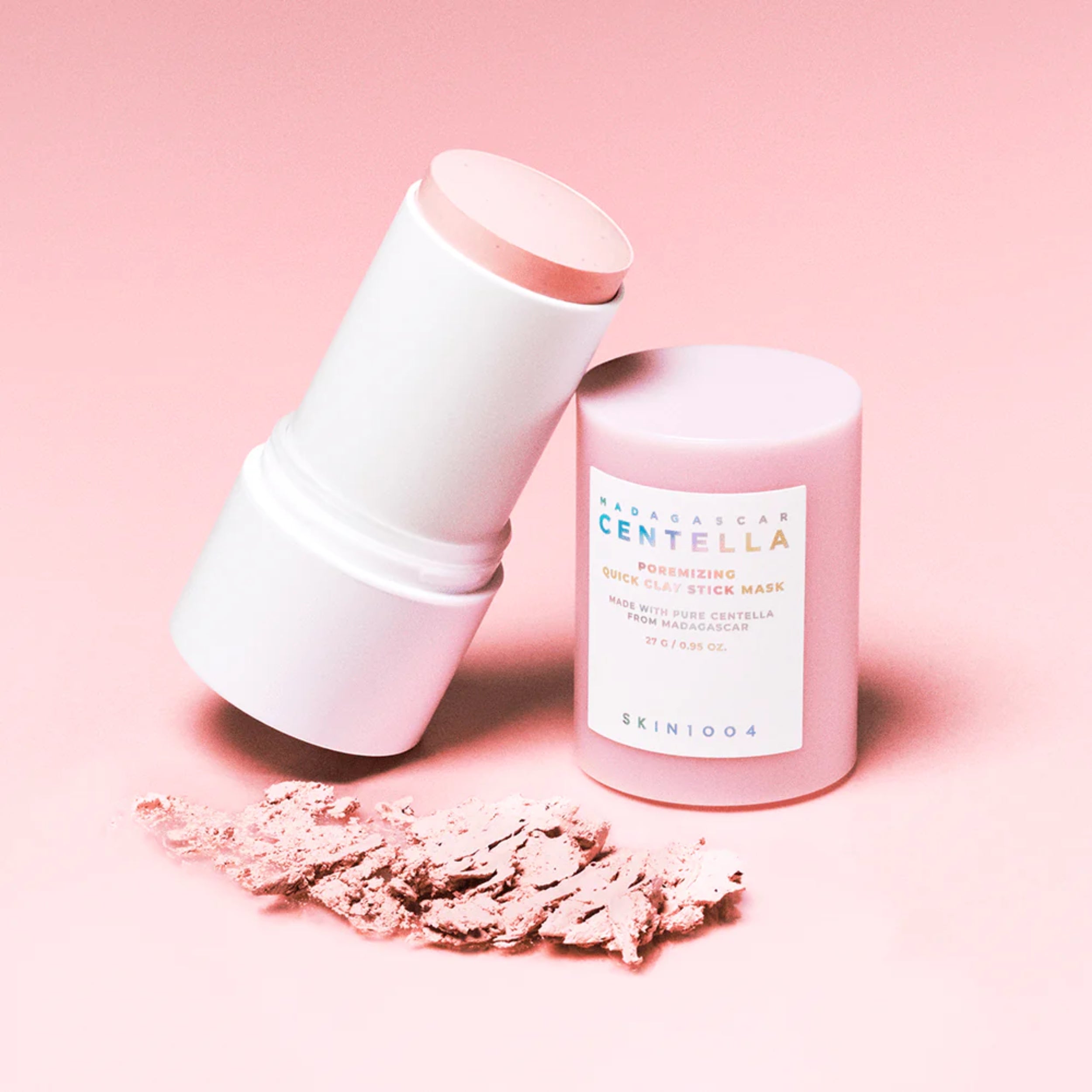 Skincare product with a stick applicator and container on a pink background