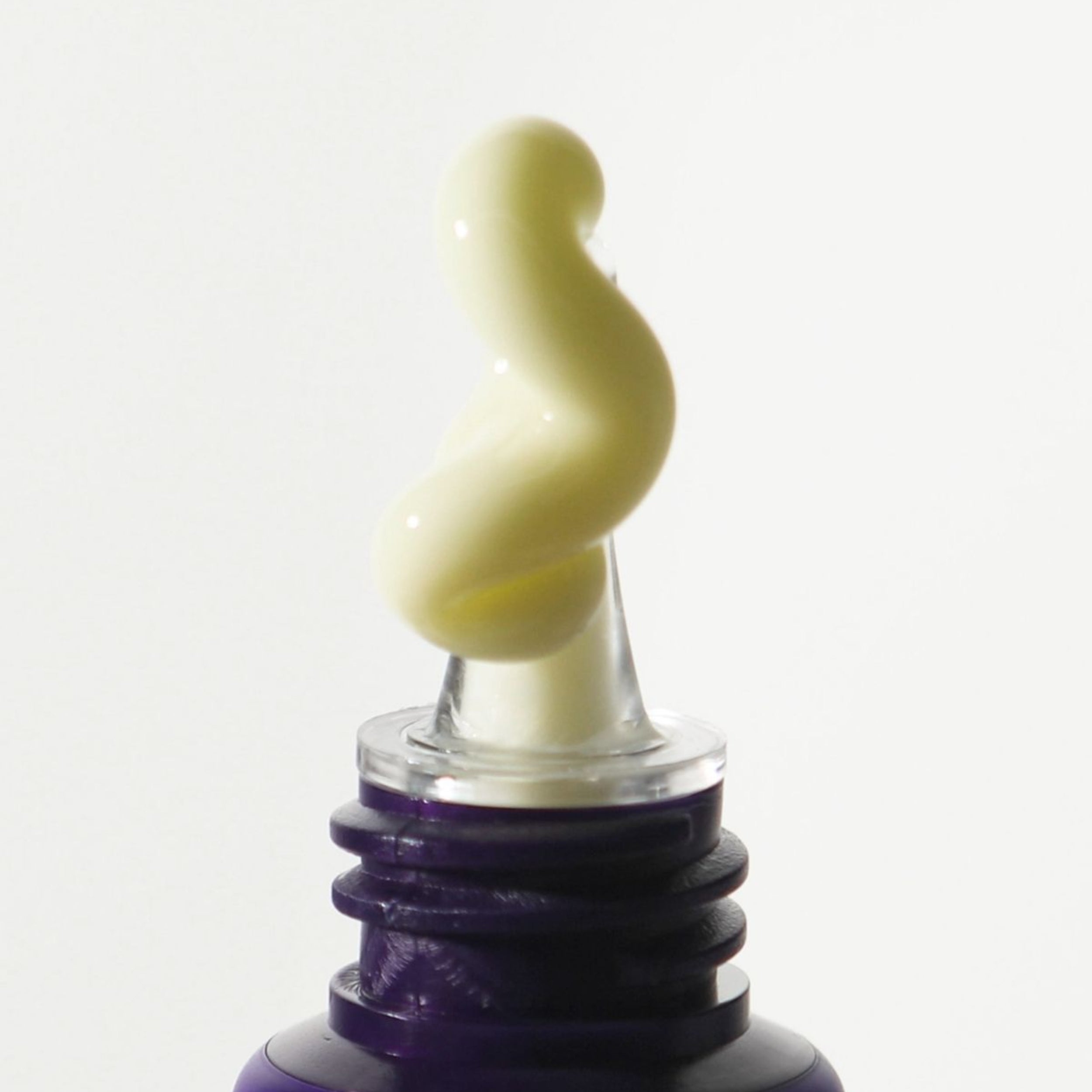 Close-up of a bottle cap with a white swirled design on a white background