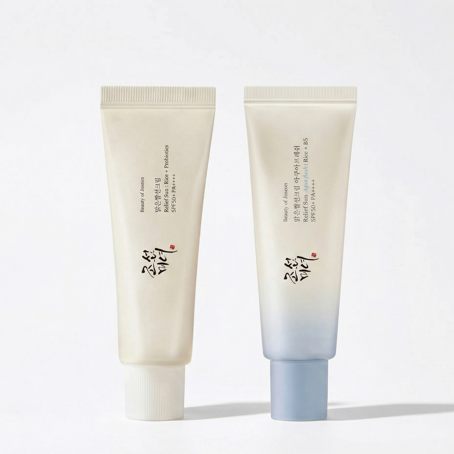 Two beauty of joseon sun care products with a gradient design on a light background