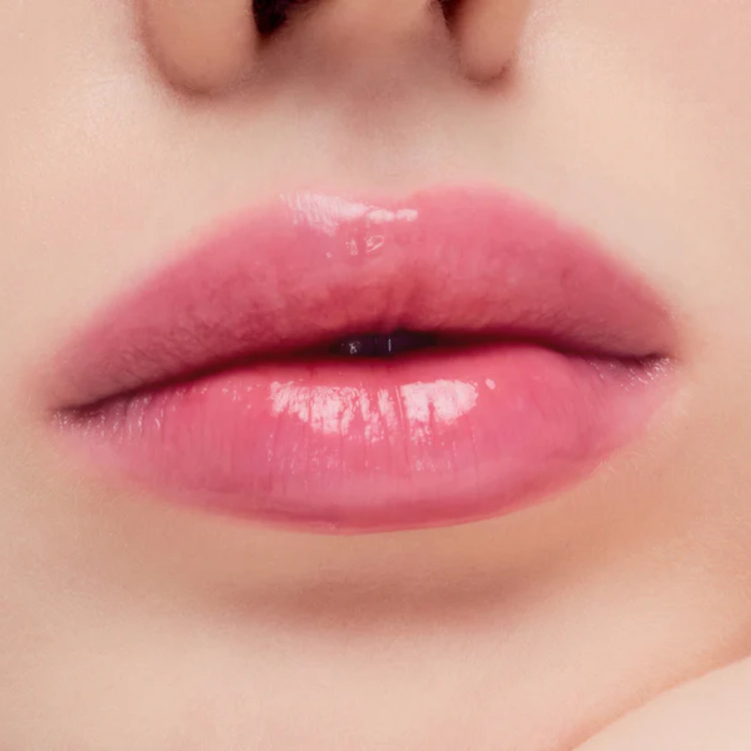 Close-up of glossy pink lips